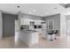 Bright kitchen with an island, bar seating, white cabinetry, and modern stainless steel appliances at 1275 Huntington St, North Port, FL 34288
