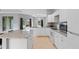 Bright kitchen features white cabinets, granite countertops, and stainless steel appliances at 1275 Huntington St, North Port, FL 34288