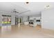 Spacious living room featuring tile flooring, ceiling fan, and sliding glass doors to outdoor space at 1275 Huntington St, North Port, FL 34288