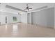Bright and open living space featuring tile flooring, tray ceilings, and natural light from windows at 1275 Huntington St, North Port, FL 34288