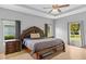 Main bedroom features decorative tray ceiling, large windows, and tile flooring at 1275 Huntington St, North Port, FL 34288