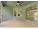 A tiled outdoor patio features a screened enclosure and a ceiling fan at 1275 Huntington St, North Port, FL 34288