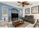 The living room is well-lit with a ceiling fan and cozy leather seating at 1313 Wise Dr, North Port, FL 34286