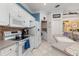 Well-lit kitchen featuring a microwave, modern stove and tile flooring at 1313 Wise Dr, North Port, FL 34286
