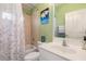 Traditional bathroom features a tub with shower and floral shower curtain at 1313 Wise Dr, North Port, FL 34286