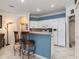 The kitchen features a breakfast bar, white cabinets, and modern appliances at 1313 Wise Dr, North Port, FL 34286