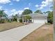 View of the home showing the garage, a long driveway and well-manicured front yard at 1313 Wise Dr, North Port, FL 34286