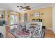 Open dining room with a decorative ceiling fan, light yellow walls, and a large table at 1313 Wise Dr, North Port, FL 34286