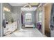 Bright, spacious bathroom with double sinks, storage bench, and natural light from a window at 1313 Wise Dr, North Port, FL 34286