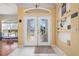 Bright foyer with decorative glass doors and shelving alcoves at 1313 Wise Dr, North Port, FL 34286