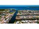 Aerial view of waterfront homes on canal with direct access to the open bay at 148 Peckham St Se, Port Charlotte, FL 33952