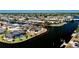 Aerial view of waterfront homes on canal with direct access to the open bay at 148 Peckham St Se, Port Charlotte, FL 33952