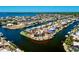 Aerial view of waterfront homes on canal with direct access to the open bay at 148 Peckham St Se, Port Charlotte, FL 33952