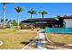 Screened-in lanai in backyard overlooking lawn and waterfront canal at 148 Peckham St Se, Port Charlotte, FL 33952