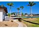 Backyard featuring an air conditioning unit, waterfront view, and tropical landscaping at 148 Peckham St Se, Port Charlotte, FL 33952