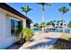 Backyard with tropical landscaping, waterfront views, and a concrete patio space at 148 Peckham St Se, Port Charlotte, FL 33952