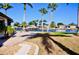 The backyard has a concrete patio, waterfront views, and tropical landscaping at 148 Peckham St Se, Port Charlotte, FL 33952