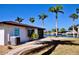 The backyard features an air conditioning unit, a waterside view, and tropical landscaping at 148 Peckham St Se, Port Charlotte, FL 33952