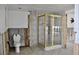 Bathroom showcases a framed shower stall, toilet, and tiled walls, awaiting personalized updates at 148 Peckham St Se, Port Charlotte, FL 33952