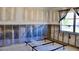 Bedroom featuring a metal bed frame, large window, and incomplete drywall at 148 Peckham St Se, Port Charlotte, FL 33952