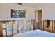 View of bedroom with colorful painting, doorway amid exposed studs and tiled floor at 148 Peckham St Se, Port Charlotte, FL 33952