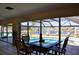 Bright dining area with large windows offering views of the pool and scenic waterfront at 148 Peckham St Se, Port Charlotte, FL 33952