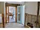 Tile entryway features an aqua door and a view of a sunlit dining area, ready for redesign at 148 Peckham St Se, Port Charlotte, FL 33952