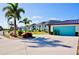 Beautiful home showcasing a well-manicured lawn, lush landscaping, and a convenient two-car garage at 148 Peckham St Se, Port Charlotte, FL 33952