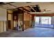 Living room with bathroom transition exposes wall framing with view to a lake through the patio door at 148 Peckham St Se, Port Charlotte, FL 33952