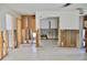 Spacious living room features open layout with exposed framing and terrazzo flooring, ready for customization at 148 Peckham St Se, Port Charlotte, FL 33952