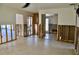 Living room with open floor plan reveals exposed framing, tile floor, and great potential for renovation at 148 Peckham St Se, Port Charlotte, FL 33952