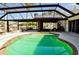 Screened-in patio with a beautiful pool and canal waterfront views at 148 Peckham St Se, Port Charlotte, FL 33952