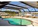Screened-in pool area featuring a swimming pool and lounge chairs with waterfront views at 148 Peckham St Se, Port Charlotte, FL 33952