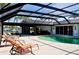 Screened-in pool area featuring a swimming pool and lounge chairs with waterfront views and home exterior at 148 Peckham St Se, Port Charlotte, FL 33952