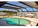 Screened-in pool area featuring a swimming pool and lounge chairs with waterfront views at 148 Peckham St Se, Port Charlotte, FL 33952