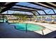 Screened-in pool area featuring a swimming pool and lounge chairs with waterfront views at 148 Peckham St Se, Port Charlotte, FL 33952