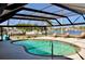 Screened-in pool area featuring a swimming pool and lounge chairs with waterfront views at 148 Peckham St Se, Port Charlotte, FL 33952