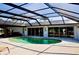 Outdoor screened patio with a beautiful in-ground pool and sliding glass doors to enter the home at 148 Peckham St Se, Port Charlotte, FL 33952