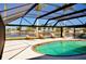 Screened-in patio with a beautiful pool and canal waterfront views at 148 Peckham St Se, Port Charlotte, FL 33952
