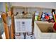 A modern tankless water heater is installed next to a utility sink in the partially finished space at 148 Peckham St Se, Port Charlotte, FL 33952