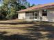 Expansive backyard featuring a screened-in porch, and well-maintained lawn, ideal for outdoor gatherings at 1488 Squaw Ln, North Port, FL 34286