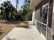 Backyard featuring a screened-in lanai and lush landscaping at 1488 Squaw Ln, North Port, FL 34286