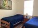 Bedroom featuring twin beds with nightstand and lots of natural light at 1488 Squaw Ln, North Port, FL 34286