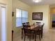 Cozy dining area with a wooden table, decorative accents, and bright natural light at 1488 Squaw Ln, North Port, FL 34286