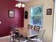 Stylish dining area with a marble table, modern chairs, and a view of the outdoors at 1488 Squaw Ln, North Port, FL 34286