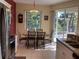 Bright dining area with views of the backyard through a large window and sliding doors at 1488 Squaw Ln, North Port, FL 34286