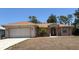 Charming single-story home featuring a well-maintained lawn, mature palm tree, and inviting front entrance at 1488 Squaw Ln, North Port, FL 34286
