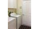 Laundry room featuring white washer and dryer, as well as cabinet space at 1488 Squaw Ln, North Port, FL 34286
