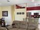Open-concept living room showing the sofa and adjacent kitchen at 1488 Squaw Ln, North Port, FL 34286