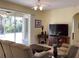 Cozy living room featuring comfortable seating, a TV, and a view of the screened patio at 1488 Squaw Ln, North Port, FL 34286